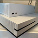 The Xbox Series X sitting atop the much larger Xbox One S.